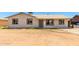 Single-story home with a neutral color scheme, simple landscaping, and a welcoming entrance at 6335 W Osborn Rd, Phoenix, AZ 85033