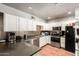 Functional kitchen with stainless steel appliances, ample counter space, and tile flooring at 6335 W Osborn Rd, Phoenix, AZ 85033