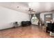 Living room with tile flooring, ceiling fan, window, and door leading to the outside at 6335 W Osborn Rd, Phoenix, AZ 85033