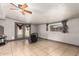 Living room with tile flooring, ceiling fan and view of the exterior through the window at 6335 W Osborn Rd, Phoenix, AZ 85033
