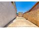 Side yard area with a concrete slab, leading to a storage shed, offering utility and convenience at 6335 W Osborn Rd, Phoenix, AZ 85033
