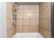 Enclosed shower with tiled walls and showerhead fixture. Clean and functional at 6335 W Osborn Rd, Phoenix, AZ 85033