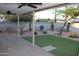 Outdoor patio has artificial grass, shaded trees, and paver flooring at 6702 E Almeria Rd, Scottsdale, AZ 85257