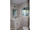 Updated bathroom featuring a marble vanity top, mirror, and bright natural light at 6702 E Almeria Rd, Scottsdale, AZ 85257