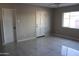 Bright bedroom featuring tile flooring, a ceiling fan, and a large window for natural light at 6702 E Almeria Rd, Scottsdale, AZ 85257