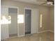 Spacious bedroom features modern closets, ceiling fan, and tiled floor at 6702 E Almeria Rd, Scottsdale, AZ 85257
