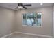 Bright bedroom has a modern ceiling fan and a large window with a backyard view at 6702 E Almeria Rd, Scottsdale, AZ 85257