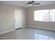 Bright bedroom featuring tile flooring, a ceiling fan, and a large window for natural light at 6702 E Almeria Rd, Scottsdale, AZ 85257