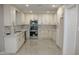 Newly renovated kitchen boasts white cabinetry, marble countertops, and stainless-steel appliances at 6702 E Almeria Rd, Scottsdale, AZ 85257