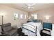 Cozy bedroom with a ceiling fan and comfortable seating area at 6937 W Jackrabbit Ln, Peoria, AZ 85383