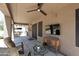 Relaxing covered patio with comfortable seating, ceiling fan, and outdoor entertainment space at 6937 W Jackrabbit Ln, Peoria, AZ 85383