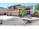 Attractive two-story home featuring a three-car garage and low-maintenance desert landscaping at 6937 W Jackrabbit Ln, Peoria, AZ 85383