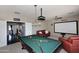 Spacious game room with a pool table and comfortable seating area at 6937 W Jackrabbit Ln, Peoria, AZ 85383