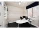 Bright home office with built-in storage, large desk, and neutral paint scheme at 6937 W Jackrabbit Ln, Peoria, AZ 85383
