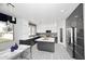 Modern kitchen features white cabinets, stainless steel appliances, and a gray island at 6937 W Jackrabbit Ln, Peoria, AZ 85383