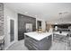 Bright kitchen features a large island, gray cabinets, and stainless steel refrigerator at 6937 W Jackrabbit Ln, Peoria, AZ 85383