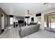 Spacious living room featuring gray sofa, ceiling fan, and large sliding glass doors at 6937 W Jackrabbit Ln, Peoria, AZ 85383