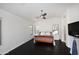 Spacious bedroom with dark wood floors, a ceiling fan, and bright windows at 6937 W Jackrabbit Ln, Peoria, AZ 85383
