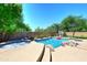 Sparkling pool with rock waterfall, spa, and lush landscaping for a relaxing backyard experience at 6937 W Jackrabbit Ln, Peoria, AZ 85383