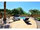 Beautiful pool area featuring lounge chairs, a waterfall feature, and lush landscaping at 6937 W Jackrabbit Ln, Peoria, AZ 85383