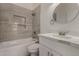 Bathroom showcasing tub, stylish tile, and single vanity at 723 E Piute Ave, Phoenix, AZ 85024