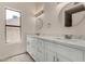 A bathroom featuring double sinks, bright lighting, and tiled floors at 723 E Piute Ave, Phoenix, AZ 85024