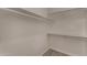 Walk-in closet features built-in shelving and wood-look tile flooring at 723 E Piute Ave, Phoenix, AZ 85024
