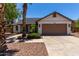 Attractive single-story home with desert landscaping, mature palm trees, and an attached two-car garage at 723 E Piute Ave, Phoenix, AZ 85024