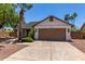 Charming single-story home with a well-maintained lawn, mature trees, and a two-car garage at 723 E Piute Ave, Phoenix, AZ 85024