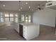 Modern kitchen features a large island with pendant lighting, stainless steel appliances and tiled floors at 723 E Piute Ave, Phoenix, AZ 85024
