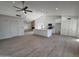 Spacious living room features a white kitchen, large island, modern ceiling fan, and tiled floors at 723 E Piute Ave, Phoenix, AZ 85024