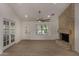 Open living area featuring tile flooring, a statement fireplace, and glass paneled doors to the exterior at 723 E Piute Ave, Phoenix, AZ 85024