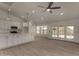 A modern living room featuring a bright kitchen, tiled floors, recessed lighting, and sliding glass doors to the backyard at 723 E Piute Ave, Phoenix, AZ 85024
