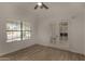 A modern office featuring a ceiling fan, tiled floors, a bright window, and glass paneled french doors at 723 E Piute Ave, Phoenix, AZ 85024