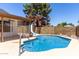 View of the pool with slide surrounded by desert landscaping at 723 E Piute Ave, Phoenix, AZ 85024