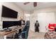 This room is the ideal workspace, featuring multiple monitors, gaming chair, and carpeted floors at 7724 W Oraibi Dr, Glendale, AZ 85308