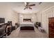 Comfortable bedroom with ceiling fan, bay window, and neutral color scheme at 7724 W Oraibi Dr, Glendale, AZ 85308