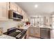 Bright kitchen featuring stainless steel appliances, including oven, microwave, and dishwasher at 7724 W Oraibi Dr, Glendale, AZ 85308