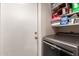The laundry room features a newer washer and dryer and convenient shelving for additional storage at 7724 W Oraibi Dr, Glendale, AZ 85308