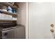 Convenient laundry room with modern washer and dryer, plus shelving for storage at 7724 W Oraibi Dr, Glendale, AZ 85308