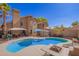 Resort style pool with ample patio space for relaxing and soaking up the sun, with an attached outdoor kitchen at 7724 W Oraibi Dr, Glendale, AZ 85308