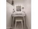 Cozy vanity with lighted mirror and neutral-toned stool at 7724 W Oraibi Dr, Glendale, AZ 85308