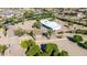 Aerial shot of desert home showcasing the surrounding desert landscape, well kept yard, and circular driveway at 8043 E Laurel St, Mesa, AZ 85207
