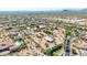An aerial view of the property, showcasing mature desert landscaping, multiple buildings, and expansive open space at 8043 E Laurel St, Mesa, AZ 85207