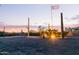 Backyard with flag pole, desert landscaping, and a pink hued sky at dusk at 8043 E Laurel St, Mesa, AZ 85207