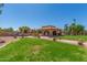 Lush backyard features a gazebo, ramada, pool, and ample green space, perfect for outdoor activities at 8043 E Laurel St, Mesa, AZ 85207