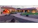 Outdoor kitchen with gas grill under an archway, large backyard, with a stone paved pathway at 8043 E Laurel St, Mesa, AZ 85207