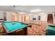 Open basement featuring pool table, ping pong table, neutral decor and colorful doors at 8043 E Laurel St, Mesa, AZ 85207