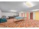 Spacious recreation room with a ping pong and billiard table, and colorful doors in the basement at 8043 E Laurel St, Mesa, AZ 85207