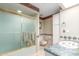Bathroom featuring sliding glass shower doors, tile counters and flooring, and a toilet at 8043 E Laurel St, Mesa, AZ 85207